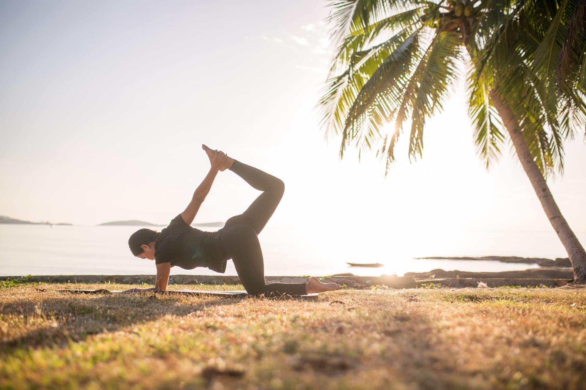 Group yoga at sunset on a Koh Samui beach